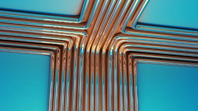 Copper pipes forming a cross shape on blue background
